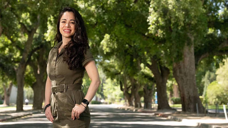 Mayté Frías in front of trees