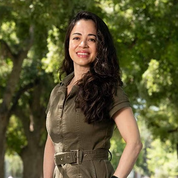 Mayté Frías in front of trees