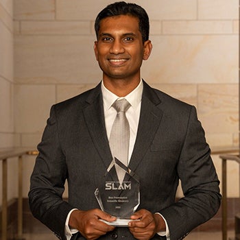 Yashwanth Balaji holding glass trophy