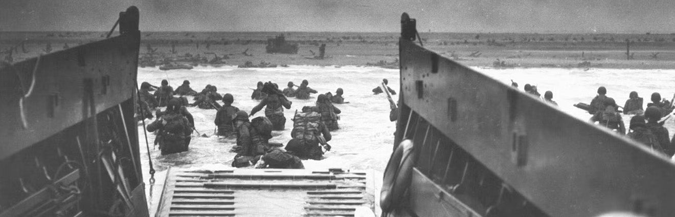 Soldiers leaving boat on the shores of Normandy