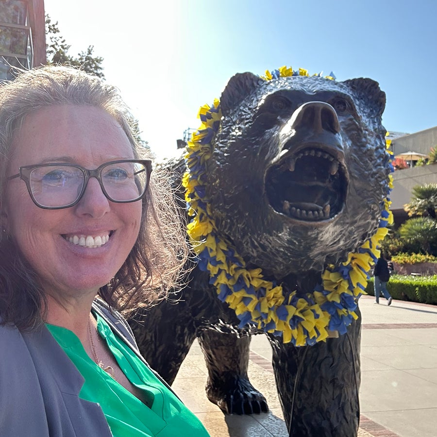 Wendy Hunter Barker next to the UCLA Bruin sculpture