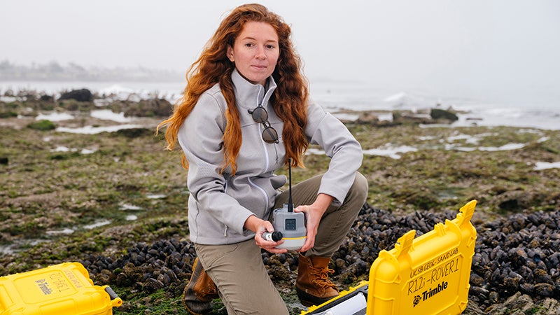 A UC Santa Barbara graduate student conducting research at Coal Oil Point Reserve