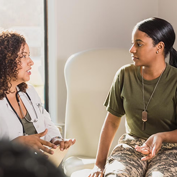Doctor talking to patient wearing military fatigues