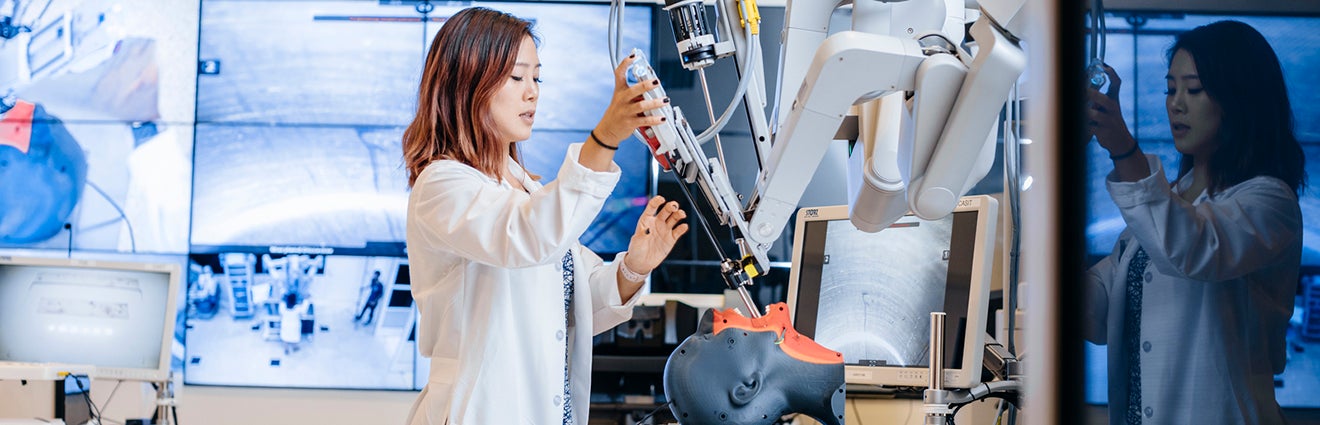 Scientist operating robotics technology