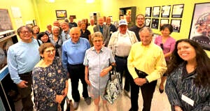 A group of retirees posing for a picture together in a UCLA building