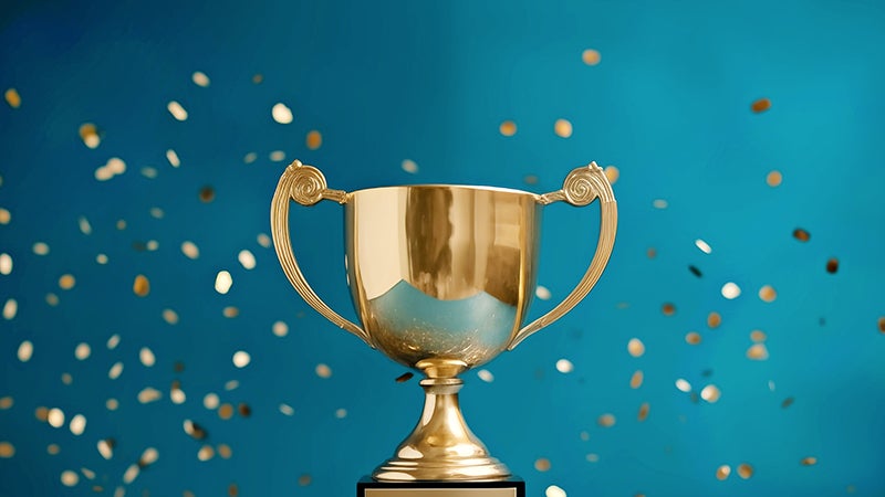 Trophy surrounded by gold confetti
