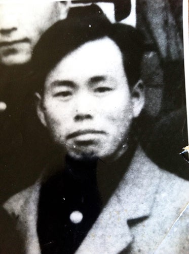 Black and white photo of a man wearing a suit