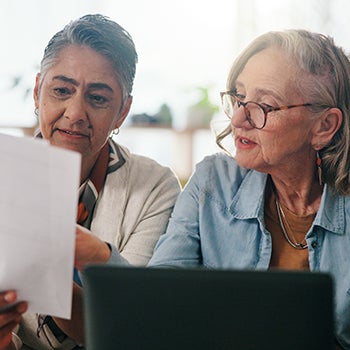 Lesbian couple working on retirement planning paperwork