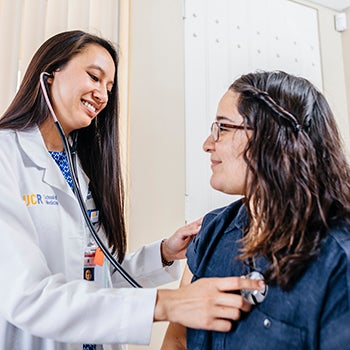 Doctor listening to patient's heart