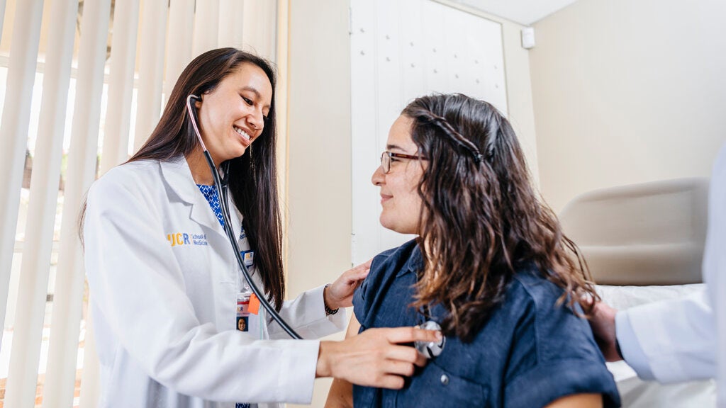 Doctor listening to patient's heart