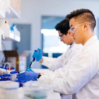Two male researchers conducting research in a lab