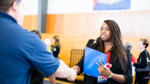 UC Merced staff person shaking hands with a student