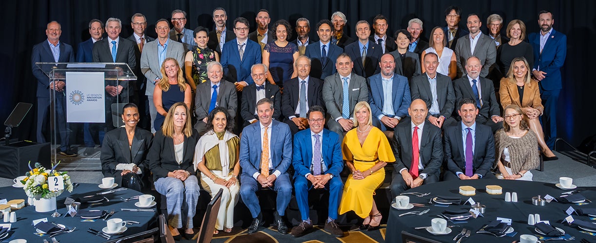 Large group of smiling people in formal attire