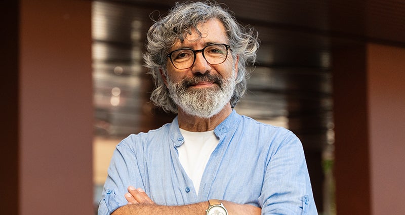 Smiling person with gray hair and beard