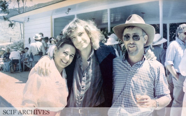 Older photo of three people with arms around one another