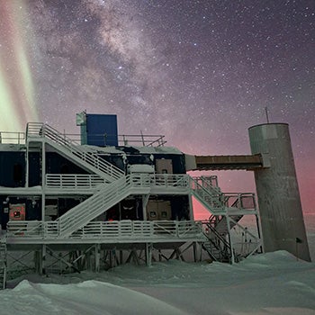 Concrete facility surrounded by stars and Northern Lights