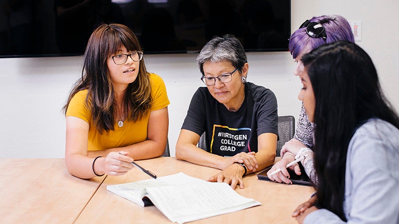 Mentor helping students with paperwork
