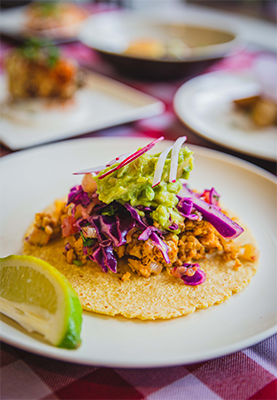 Taco, garnished with guacamole and radish, at a UCLA dining hall.