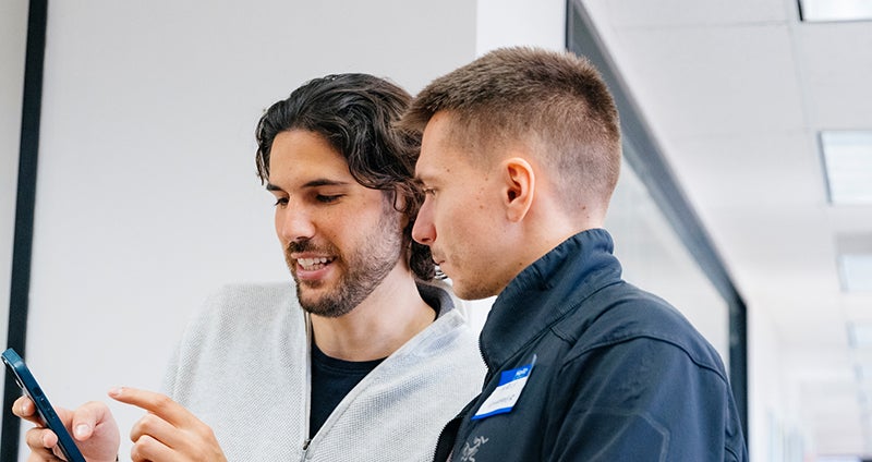 Two people looking at a phone