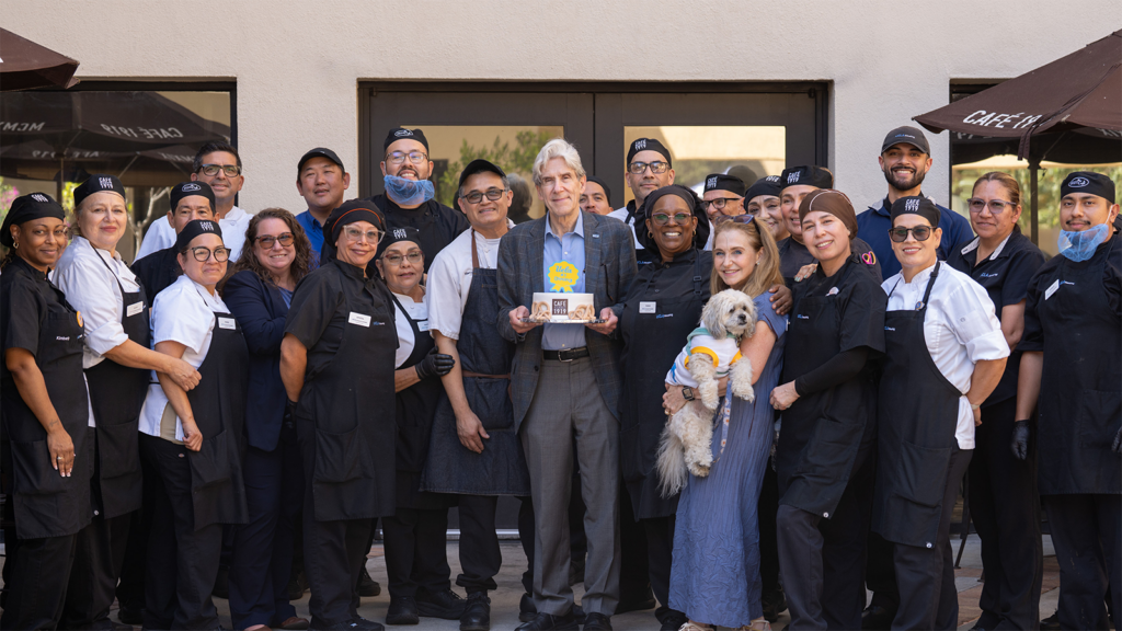 Chancellor Julio Frenk, center, and Felicia Knaul pose with staff in front of Café 1919.