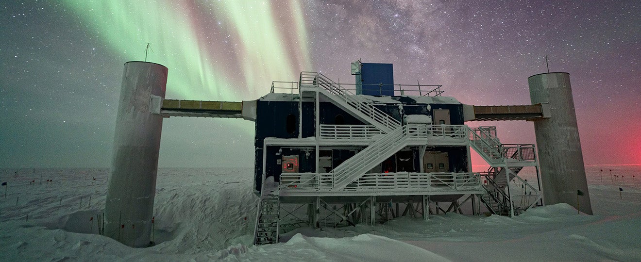 Concrete facility surrounded by stars and Northern Lights